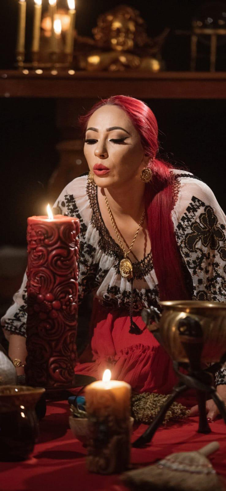 Danusia among candles, in her embroidered blouse